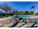 Community pool featuring a decorative fountain, plenty of seating, and meticulous landscaping at 4702 Corsage Dr, Lutz, FL 33558