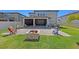 Backyard patio with fire pit and outdoor seating, perfect for entertaining at 4923 Eagle Rock Dr, Wimauma, FL 33598