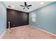 Bright bedroom with a black accent wall, a ceiling fan, and a neutral-colored carpet at 4923 Eagle Rock Dr, Wimauma, FL 33598