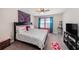 Comfortable bedroom featuring a plush bed, colorful accents, and a ceiling fan at 4923 Eagle Rock Dr, Wimauma, FL 33598