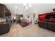 Open-concept kitchen with dark cabinets, an island, and seamless flow into the living area at 4923 Eagle Rock Dr, Wimauma, FL 33598