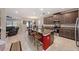 Open kitchen with an island, barstool seating, granite countertops, and stainless steel appliances at 4923 Eagle Rock Dr, Wimauma, FL 33598