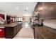 Modern kitchen with granite countertops, stainless steel appliances, and dark wood cabinets at 4923 Eagle Rock Dr, Wimauma, FL 33598