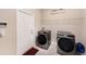 Well-lit laundry room featuring modern machines and shelving for sorting at 4923 Eagle Rock Dr, Wimauma, FL 33598