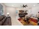 Bright living area with modern furniture, open layout, and seamless flow to the kitchen at 4923 Eagle Rock Dr, Wimauma, FL 33598