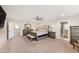 Spacious main bedroom with a ceiling fan, carpet flooring, and an ensuite bathroom at 4923 Eagle Rock Dr, Wimauma, FL 33598