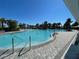 Beautiful community pool area with plenty of seating under palm trees at 4923 Eagle Rock Dr, Wimauma, FL 33598