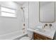Bright bathroom with a shower and tub combination and sleek fixtures at 4934 Dr Martin Luther King Jr N St, St Petersburg, FL 33703