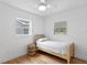 Cozy bedroom with bright windows and a rattan bed frame with wood floors at 4934 Dr Martin Luther King Jr N St, St Petersburg, FL 33703