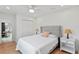 Bright bedroom featuring a queen-sized bed, white walls, wood floors, and a ceiling fan at 4934 Dr Martin Luther King Jr N St, St Petersburg, FL 33703