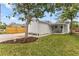 Exterior view of the home including the side outdoor dining space and driveway at 4934 Dr Martin Luther King Jr N St, St Petersburg, FL 33703