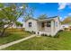 Charming single-story home with a well-manicured lawn and inviting front porch and fresh exterior paint at 4934 Dr Martin Luther King Jr N St, St Petersburg, FL 33703