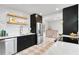 Beautiful kitchen with stainless steel appliances, floating wood shelves, and stylish tile flooring at 4934 Dr Martin Luther King Jr N St, St Petersburg, FL 33703