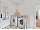 Modern laundry room with front load machines and decorative accents at 4934 Dr Martin Luther King Jr N St, St Petersburg, FL 33703