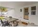 Covered outdoor patio with table and bench and door to the house at 4934 Dr Martin Luther King Jr N St, St Petersburg, FL 33703