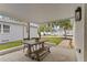 Covered outdoor patio with dining table, bench, and chairs, perfect for entertaining at 4934 Dr Martin Luther King Jr N St, St Petersburg, FL 33703