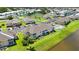 Scenic aerial view of condo community showcasing well-manicured lawns and a tranquil lake at 5800 Sabal Trace Dr # 301, North Port, FL 34287