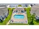 Aerial top-down view of the community pool surrounded by lounge chairs and landscaping at 5800 Sabal Trace Dr # 301, North Port, FL 34287