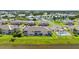 Aerial view of a condo community with a pool, community center, and lake views at 5800 Sabal Trace Dr # 301, North Port, FL 34287
