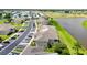 Aerial view of condo community featuring lush landscaping, lake view, and ample parking at 5800 Sabal Trace Dr # 301, North Port, FL 34287