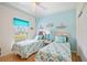 Charming bedroom with twin beds, beachy decor, and plenty of natural light at 5800 Sabal Trace Dr # 301, North Port, FL 34287