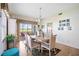 Bright dining area with elegant table, view of the outdoor space, and stylish accents at 5800 Sabal Trace Dr # 301, North Port, FL 34287