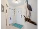 Bright foyer with tile flooring, white door, and decorative wall art at 5800 Sabal Trace Dr # 301, North Port, FL 34287