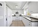 The bright kitchen features white appliances, ample counter space, and storage, perfect for cooking and entertaining at 5800 Sabal Trace Dr # 301, North Port, FL 34287