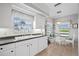 This cozy kitchen features a breakfast nook with scenic views and elegant white cabinetry, seamlessly blending style and functionality at 5800 Sabal Trace Dr # 301, North Port, FL 34287