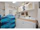 Functional laundry room with washer, dryer, and storage shelves for household needs at 5800 Sabal Trace Dr # 301, North Port, FL 34287
