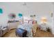Airy bedroom with natural light showcasing hardwood floors, and elegant furnishings, perfect for comfort and relaxation at 5800 Sabal Trace Dr # 301, North Port, FL 34287