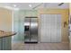 Bright kitchen featuring stainless steel refrigerator, ample storage, and tile floors at 6100 Bahia Del Mar Cir # 204, St Petersburg, FL 33715