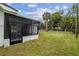 View of the screen enclosed patio in the fenced in back yard at 7310 Donna Dr, New Port Richey, FL 34652