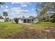 Large backyard with green grass and trees at 7310 Donna Dr, New Port Richey, FL 34652