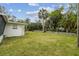 Shot of the green backyard and side of the house at 7310 Donna Dr, New Port Richey, FL 34652