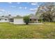 Large backyard with green grass and shaded cover at 7310 Donna Dr, New Port Richey, FL 34652
