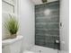 Modern bathroom with designer tile shower and floors, contrasting grout, and sleek fixtures at 7310 Donna Dr, New Port Richey, FL 34652