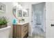 Well-lit bathroom with modern vanity, stylish mirror, and fresh decor, creating a clean and inviting space at 7310 Donna Dr, New Port Richey, FL 34652