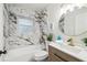 Elegant bathroom with marble-style tile, modern fixtures, and a stylish vanity, offering a luxurious and relaxing experience at 7310 Donna Dr, New Port Richey, FL 34652
