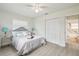 Bright bedroom with light-colored walls and floor, closet, fan, and connecting bathroom at 7310 Donna Dr, New Port Richey, FL 34652