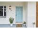 Charming front door with a welcome mat and matching potted plants at 7310 Donna Dr, New Port Richey, FL 34652