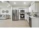 Open-concept kitchen featuring stainless steel appliances, white cabinets, and seamless flow into the adjacent living area at 7310 Donna Dr, New Port Richey, FL 34652