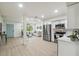 Spacious open-concept layout with kitchen and living area, featuring stainless steel appliances and comfortable seating at 7310 Donna Dr, New Port Richey, FL 34652