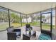 Enclosed patio featuring brick and tile, with modern outdoor furniture and backyard views at 7310 Donna Dr, New Port Richey, FL 34652