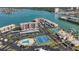 Aerial view of condo community with pool, tennis courts, lush landscaping, and parking at 7665 Sun Island S Dr # 401, South Pasadena, FL 33707
