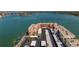 Aerial view showcases the building, parking, surrounding waterways, and lush tropical landscaping at 7665 Sun Island S Dr # 401, South Pasadena, FL 33707