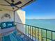 A peaceful balcony with comfortable seating and water views making a serene retreat at 7665 Sun Island S Dr # 401, South Pasadena, FL 33707
