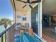 Relaxing balcony with seating and ocean views with sliders leading to the living room at 7665 Sun Island S Dr # 401, South Pasadena, FL 33707