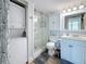 Bathroom showcasing a stackable washer/dryer, glass shower, white cabinets, and modern fixtures at 7665 Sun Island S Dr # 401, South Pasadena, FL 33707
