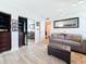 Bright bedroom featuring a closet, gray couch, and modern flooring at 7665 Sun Island S Dr # 401, South Pasadena, FL 33707